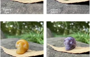 Macro detail of hand-carved natural crystal mini skull figurines on dry leaves