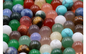 Macro shot showing polished natural green aventurine and tiger eye round stone beads