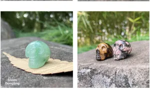 Macro view of 1-inch carved skulls in green aventurine, tiger eye, and rhodonite
