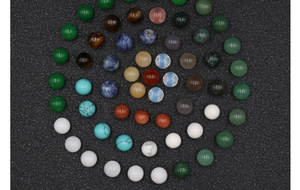 Detailed macro view of 10mm assorted natural gemstone round beads in a spiral arrangement