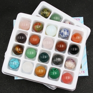 Detailed view of 20mm assorted natural crystal spheres in a 16-slot organized storage case