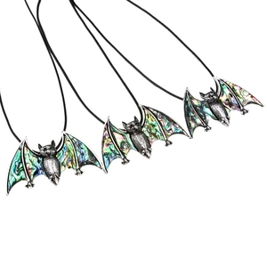 Gothic bat pendant necklace featuring colorful iridescent abalone shell wings on white base