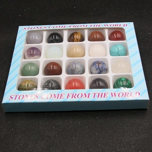 Macro shot of 20mm round gemstone spheres in a collection box with clear window