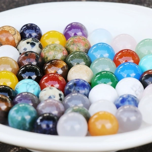 Polished 10mm natural green aventurine and mixed stone balls displayed in a white bowl