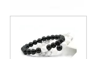 Detailed view of 8mm white turquoise and black onyx beaded bracelets in a layered stack