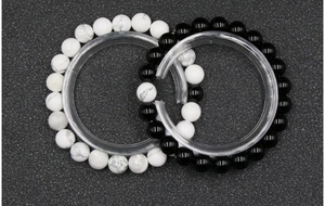 Detail of 8mm white turquoise and black onyx bead bracelets with yin yang style contrast