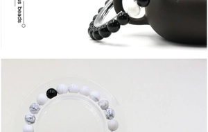Macro view of 8mm black onyx and white turquoise beads bracelets for couples