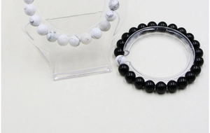 Detail of 8mm natural white turquoise and black agate beaded bracelets on display