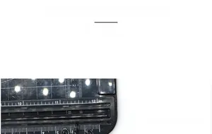 Close-up of a matte black measuring scale featuring precise inch markings and numeric details