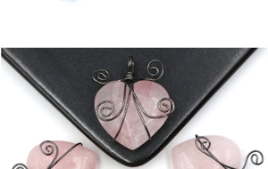 Macro view of handcrafted wire-wrapped natural rose quartz heart-shaped pendant detail