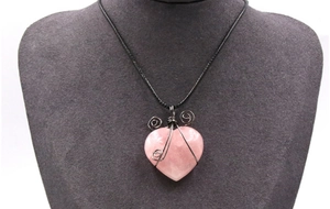 Detail of wire-wrapped rose quartz heart pendant on a black cord necklace