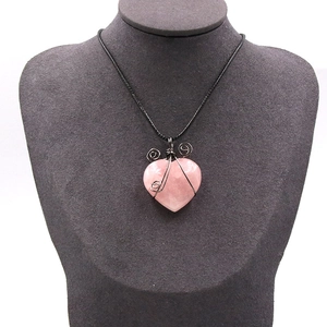 Handmade wire-wrapped heart-shaped natural rose quartz pendant necklace on a black cord