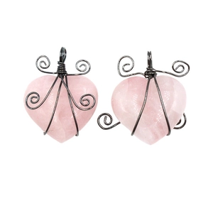 Handmade heart-shaped rose quartz pendant wrapped in black wire on a clean white background
