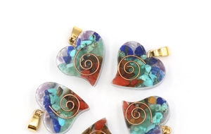 Detail of heart resin pendants with mixed natural crystal stones and copper coils