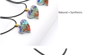 Detailed view of chakra heart pendant with colorful crushed stones and copper spiral inlay
