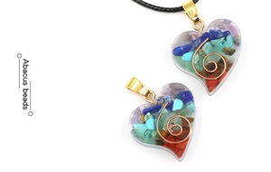 Detailed view of heart-shaped resin pendants filled with colorful natural crystals