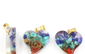 Detail view of heart-shaped resin pendants filled with colorful natural crystal stones