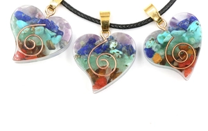 Macro detail of heart resin pendants with natural chakra stones and metal spiral coil