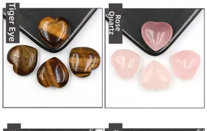 Detailed view of polished tiger eye and rose quartz heart stones on a display stand