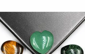 Macro shot of 25mm heart-shaped green aventurine and tiger eye natural stones