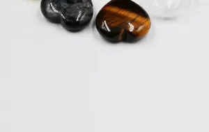 Macro detail of polished heart-shaped tiger eye and labradorite natural gemstone hearts