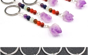 Macro shot of durable metal keychain ring with raw amethyst and chakra beads