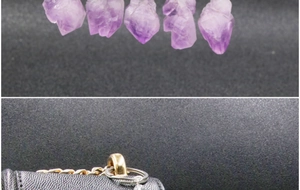 Natural amethyst crystal pendant keychain shown as a charm on a grey leather bag