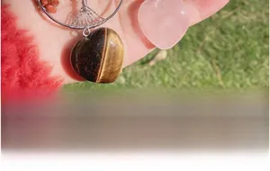 Detailed wire-wrapped Tree of Life pendant with Tiger Eye and Rose Quartz heart stones