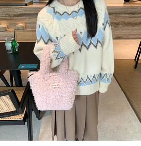 Pink plush faux fur handbag styled with a knitted sweater and pleated skirt