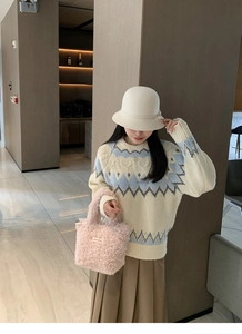 Pink curly plush handbag styled with a knitted geometric sweater and pleated midi skirt