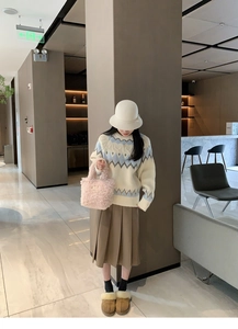 Fashionable pink plush mini handbag styled with an autumn outfit in a modern hall