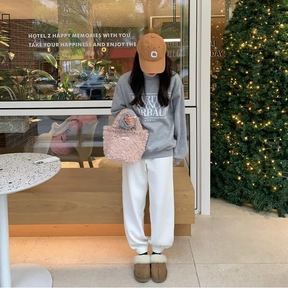 Fashionable pink plush mini handbag paired with a casual grey winter sweatshirt and joggers