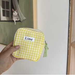 Borsetta a quadretti gialli per assorbenti con etichetta Lime e cerniera verde