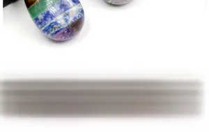Close-up of polished seven chakra layered crystal pendant with multi-colored stones