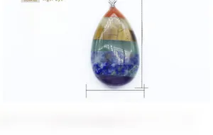 Close-up of teardrop chakra pendant made from tiered natural healing crystal stones