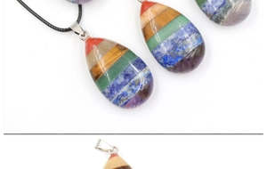 Macro shot of colorful layered teardrop chakra pendant with vibrant gemstone textures