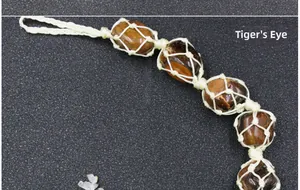 Macro shot of handcrafted tiger's eye natural stone woven in a macrame net ornament