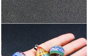 Macro shot of colorful multilayer chakra stone teardrop and egg-shaped pendants