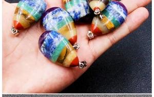 Detail of seven chakra teardrop pendants showing multi-layered natural stone layers