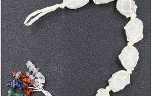 Detailed macro view of white crystal stones in handmade woven mesh for car hanging