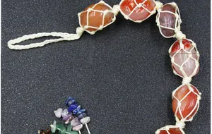 Detailed view of handmade Seven Chakra natural stones woven in a cotton rope macrame hanger