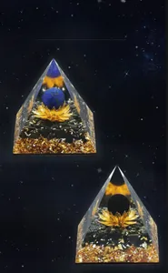 Macro detail of Orgone energy pyramid with Lapis Lazuli sphere and golden lotus base