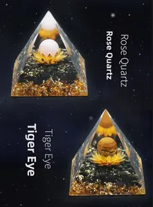 Detail of Orgone pyramid with rose quartz and tiger eye on starry background
