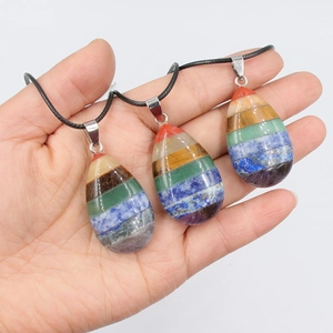 Water-drop chakra necklace with colorful natural layered stones on a black wax rope
