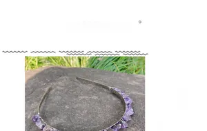 Detail of a handmade dark amethyst crystal crown featuring raw purple stones on a metal band
