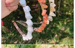 Detailed macro view of two handmade metal headbands with blue and orange raw crystal stones