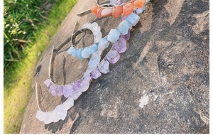 Detail of natural raw amethyst and rose quartz crystals wrapped on bridal headbands