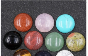 Vista dettagliata dall'alto di vari cabochon di pietre semipreziose da 20 mm per gioielli