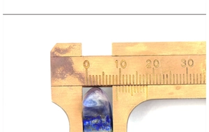 Mesure détaillée de la largeur de la pierre de lune naturelle avec un pied à coulisse