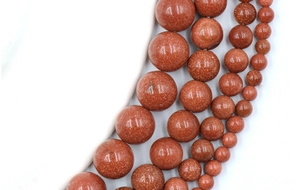 Macro shot of brown goldstone round beads with sparkling gold flecks for jewelry making